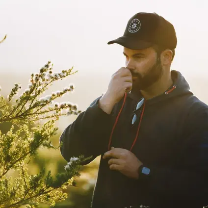 Ben from Bush Pharmacy sniffing a sprig of kunzea